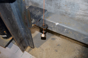 Setting the Hoistway - A plumb bob comes already installed in the hoistway of the manufactured elevator.