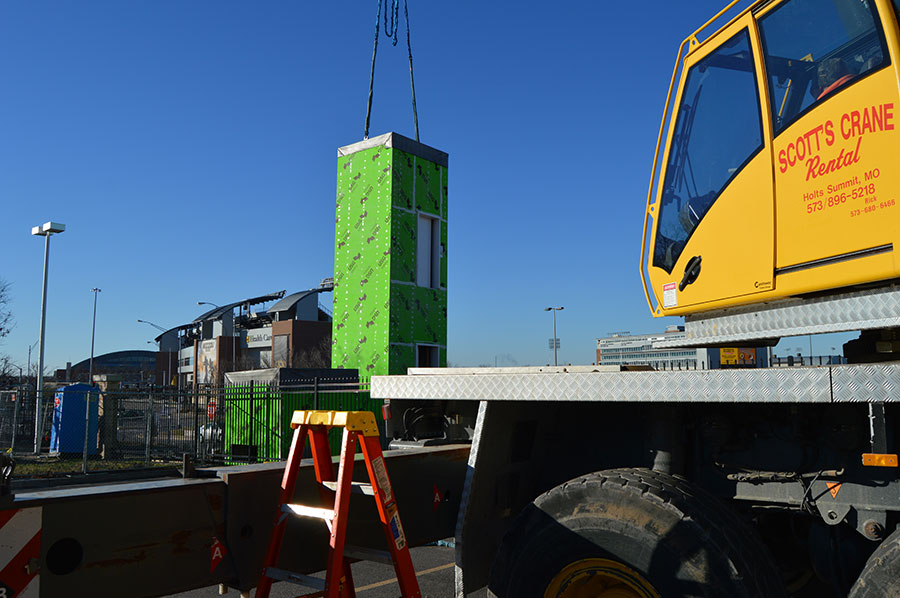 hoisting modular elevator onto flatbed truck